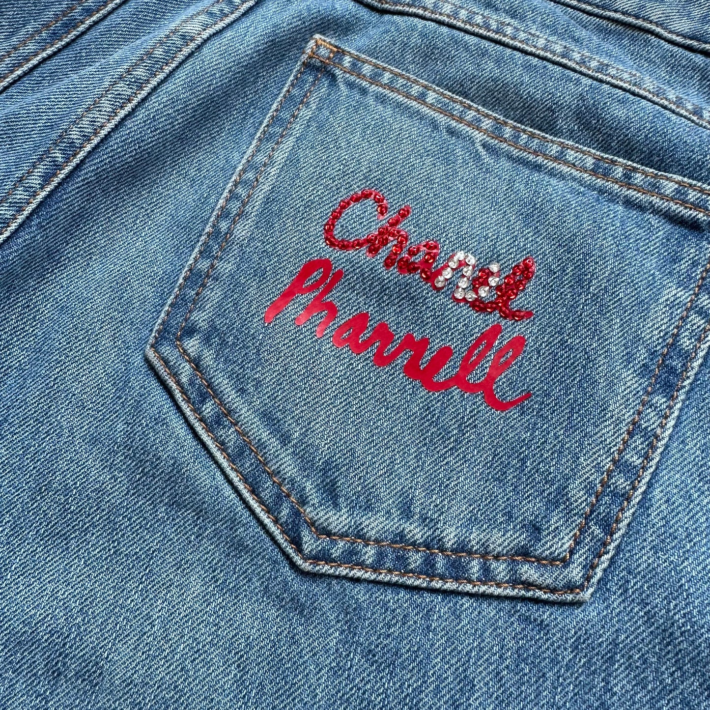 CHANEL - DENIM BLUE JEANS WITH PHARREL RED LOGO ON BACK POCKET SIZE 34 FR