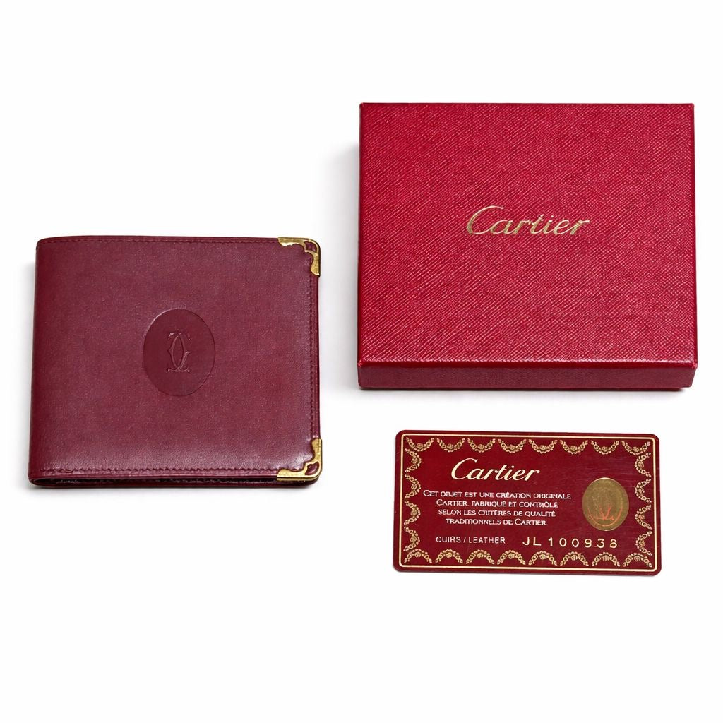 CARTIER - WALLET MUST DE CARTIER BORDEAUX LEATHER WITH GOLD-TONE CORNERS