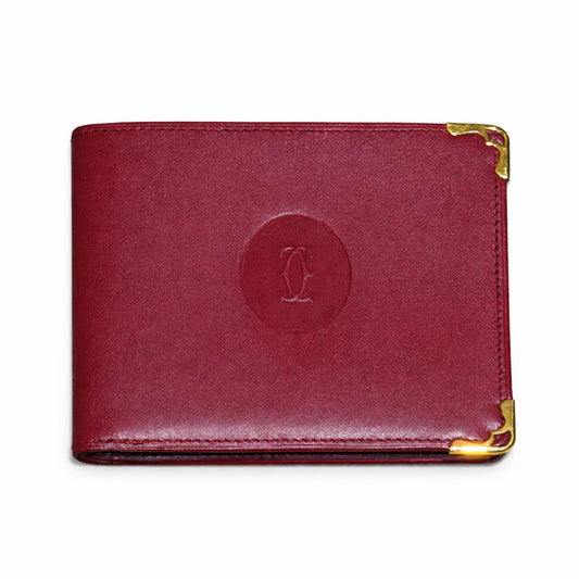 CARTIER - WALLET MUST DE CARTIER BORDEAUX LEATHER WITH GOLD-TONE CORNERS